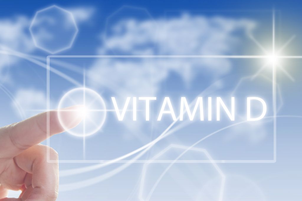 Hand reaching for the best Vitamin D glowing in the sky.