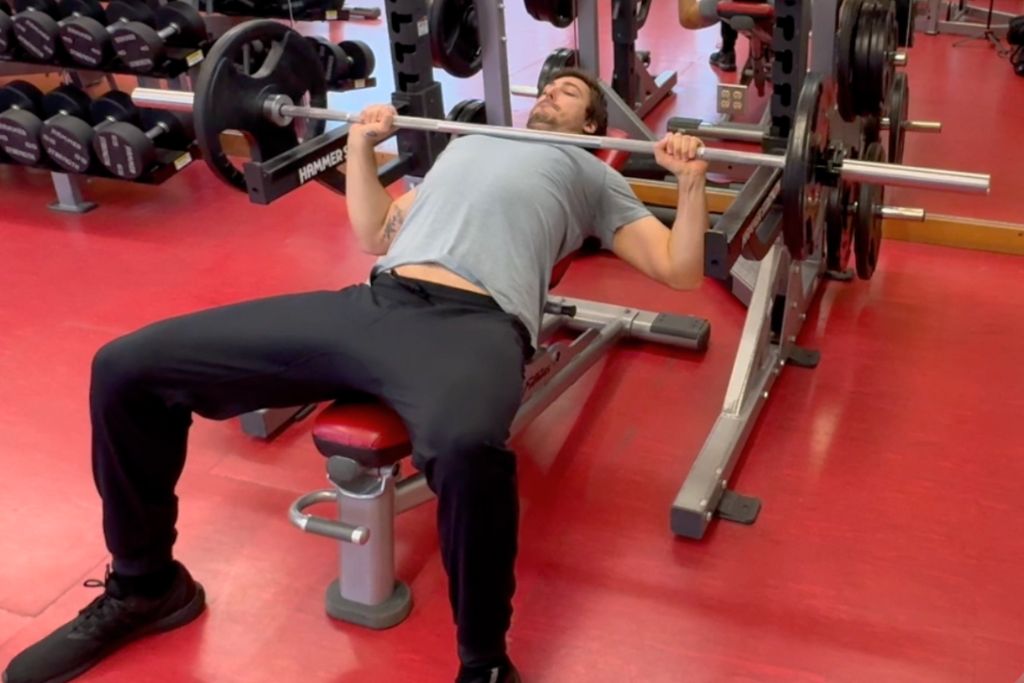 Gavin Larsen performing an incline bench press with full range of motion, demonstrating proper form for optimal joint health and muscle engagement.