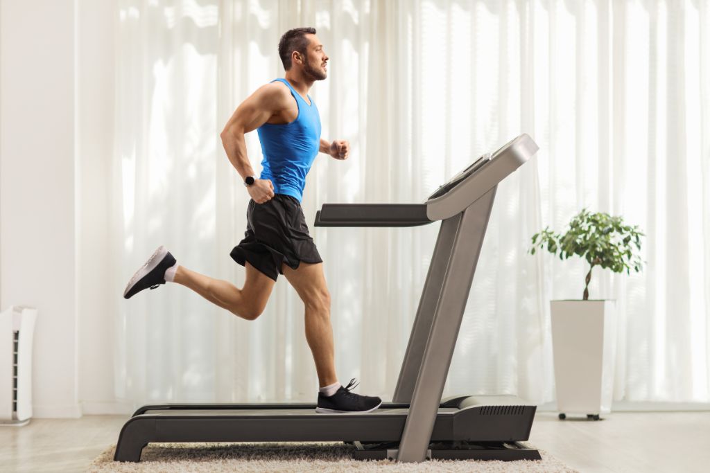 Man running on a home treadmill—exploring which treadmill is the best for home workouts.